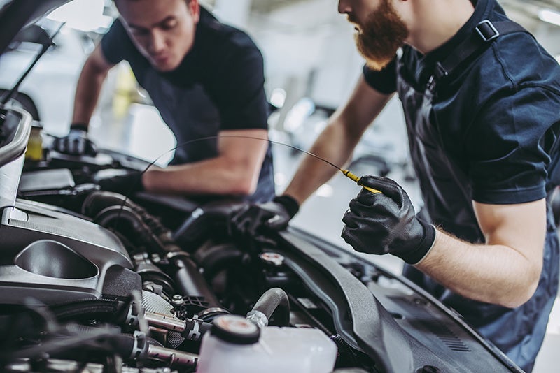 Certified Kia technician performing maintenance service
